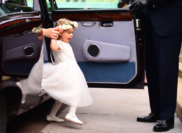 A bridesmaid arrives ahead of the wedding (Victoria Jones/PA)