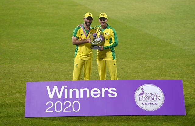 Glenn Maxwell, left, and Alex Carey pose with the trophy 