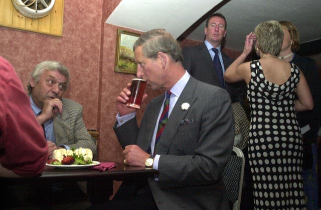 Charles enjoying a half pint of Old Speckled Hen Ale and an egg mayonaise sandwich in the Dudley Arms public house during his visit to Llandrillo in north Wales in 2002