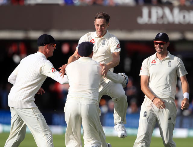 England’s Chris Woakes celebrates taking the wicket of India’s Virat Kohli
