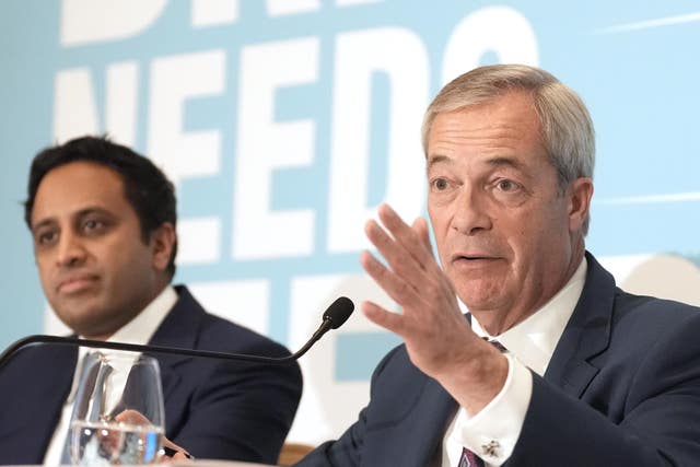 Nigel Farage, right, gesturing while sitting next to Zia Yusuf