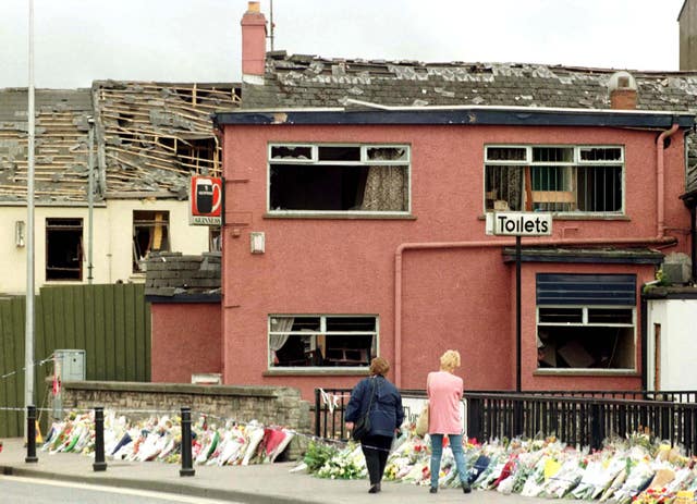 Residents of Omagh lay flowers near the scene of the bomb blast in 1998