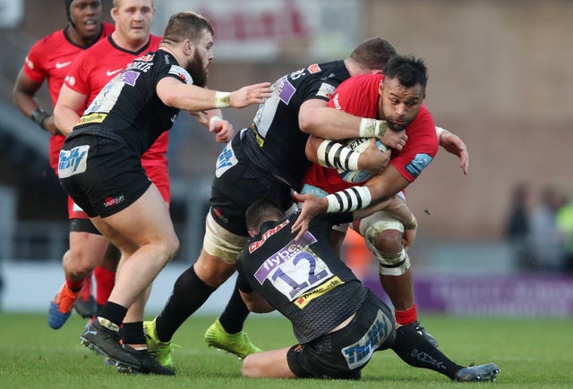 Saracens' Billy Vunipola is tackled by Exeter's Dave Ewers and Ollie Devoto 