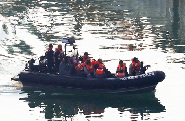 A group of men are brought to shore by Border Force officers at the Port of Dover