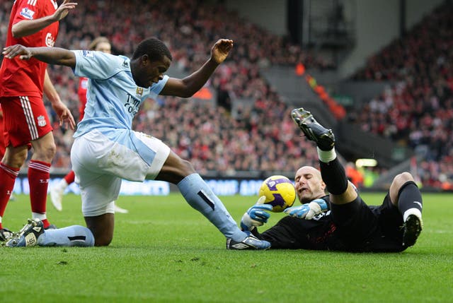 Nedum Onuoha battles for the ball with Liverpool goalkeeper Pepe Reina in February 2009