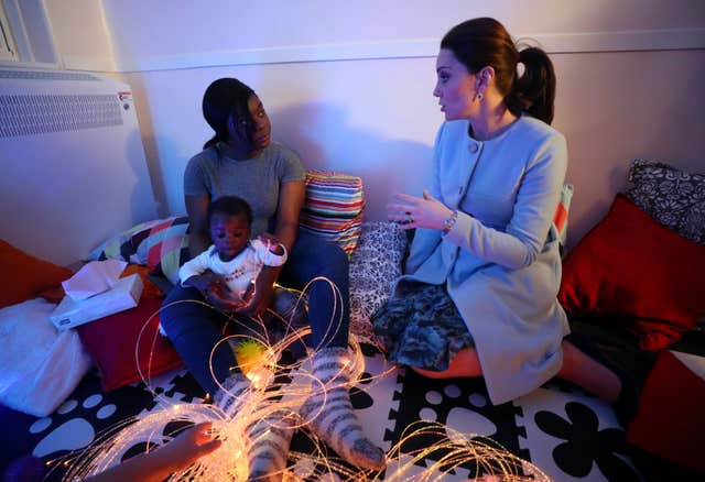 The Duchess speaks to patient, Esther, and her son Nehemiah, at the Mother and Baby unit (Hannah McKay/PA)
