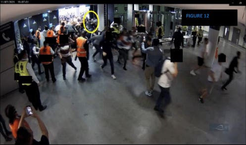 A man holding a young child is supported by a steward after he is swept in through an emergency fire door which has been forced open ahead of the Euro 2020 final at Wembley
