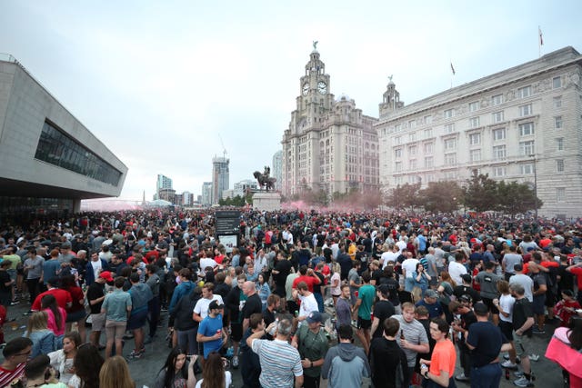 Liverpool fans let off flares outside the Liver Building in Liverpool