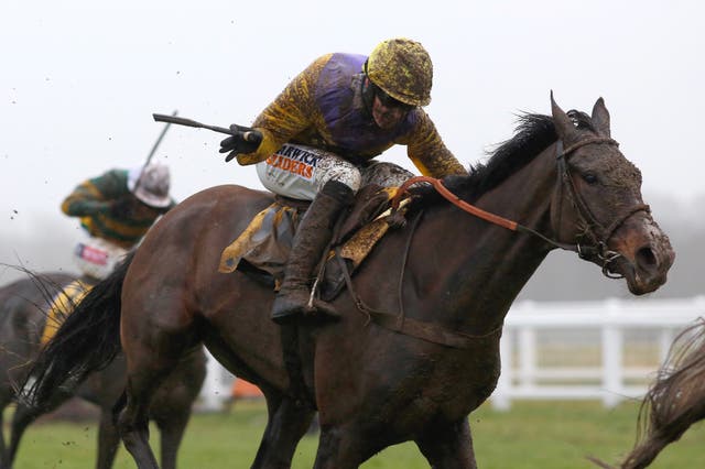 A mud-splattered Jack Quinlan and Kalashnikov on the way to winning the Betfair Hurdle at Newbury
