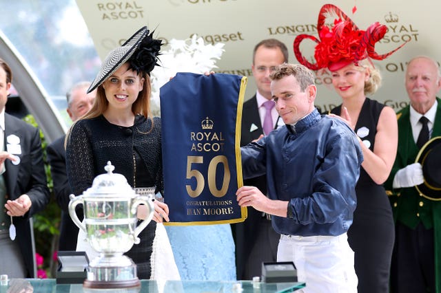 Princess Beatrice presents Ryan Moore with a memento of his 50th Royal Ascot winner