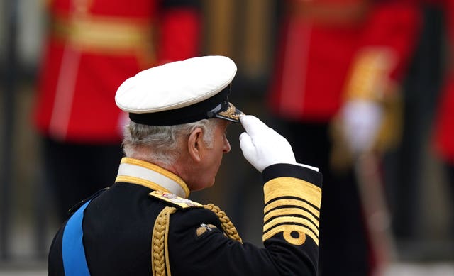 King Charles salutes the coffin of the Queen