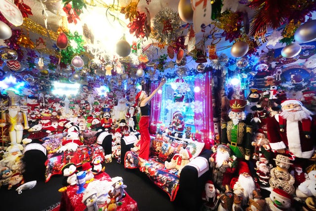 Thirteen-year-old Storm McBain puts the finishing touches to the Christmas light display and decorations at her home in Framwellgate Moor in Durham, in the north east of England, which took four weeks to install