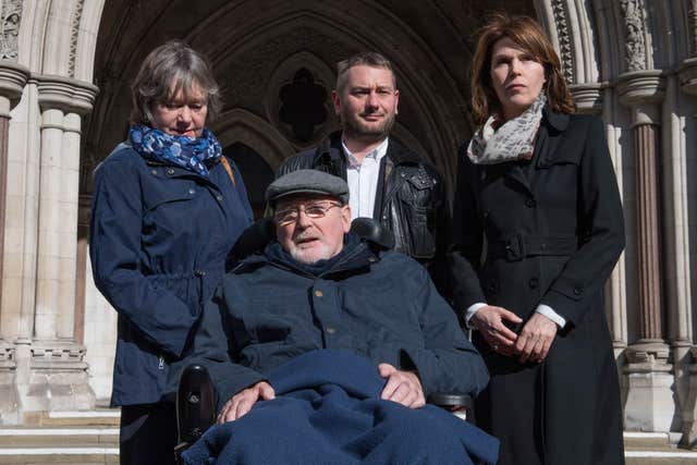 Terminally-ill retired lecturer Noel Conway, 68, with his wife Carol (left), stepson Terry McCusker (centre back) and Sarah Wootton, CEO of Dignity in Dying outside High Court in London. Stefan Rousseau/PA