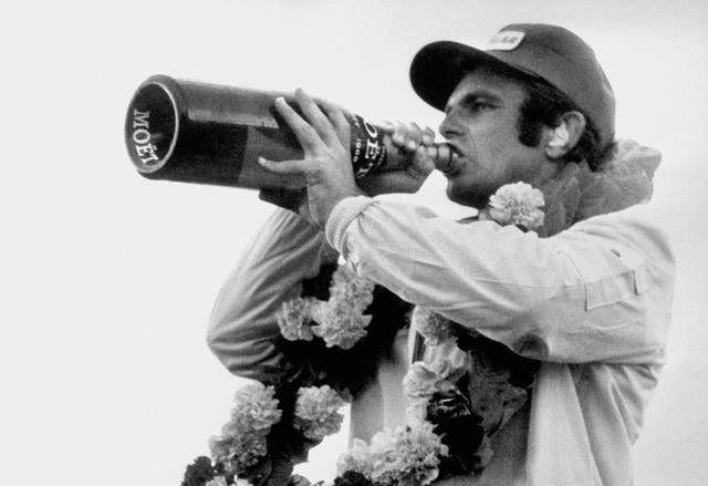 American Peter Revson enjoys a victory drink of champagne after winning the dramatic 1973 race in his Yardley-McLaren