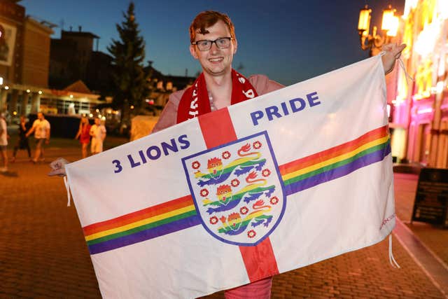 Joe White holds his flag aloft on the street in Russia