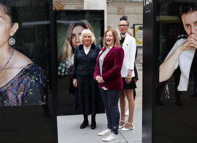The Duchess of Cornwall stands with photographer Allie Crewe