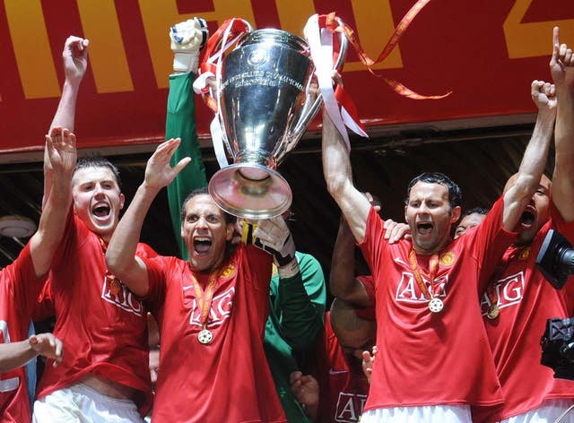 Michael Carrick celebrates as Rio Ferdinand and Ryan Giggs lift the Champions League trophy