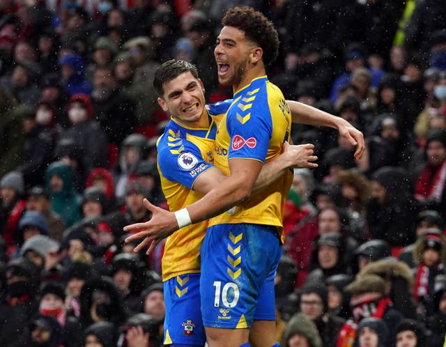Che Adams, right, and Romain Perraud celebrate at Old Trafford