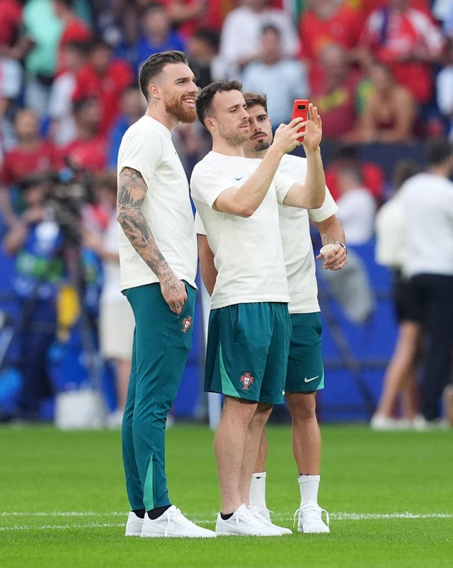 Portugal goalkeeper Jose Sa, Diogo Jota and Pedro Neto take a selfie ahead of a match at Euro 2024