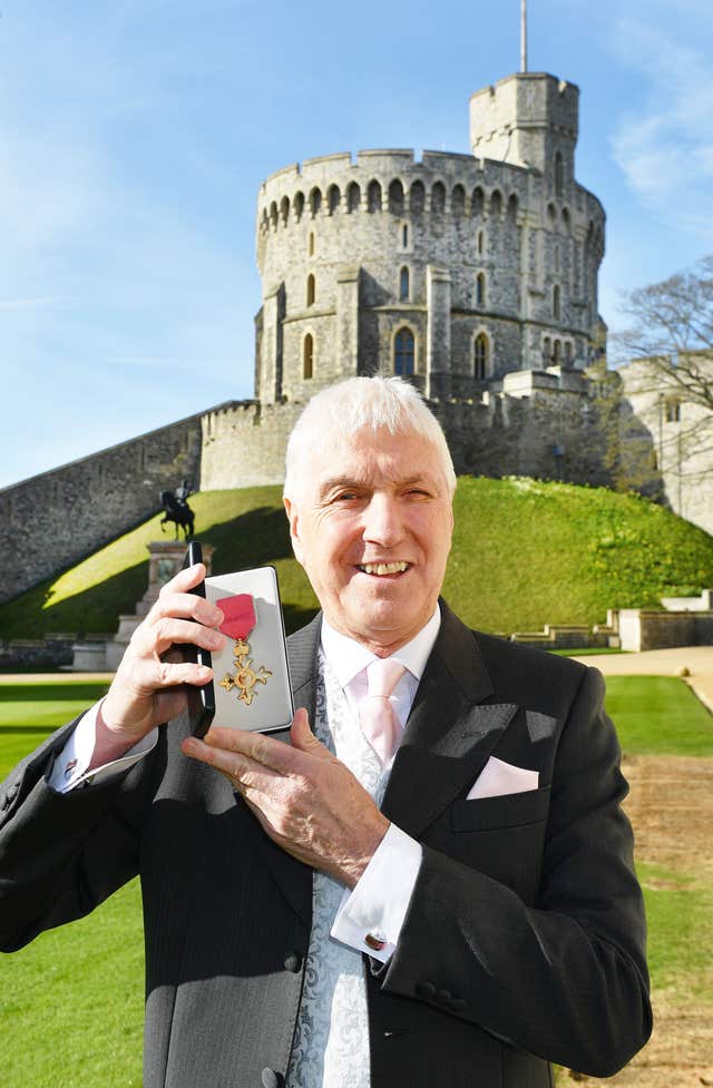 Former rugby union referee Edward Morrison holds his OBE that was presented to him by Queen Elizabeth II at an Investiture ceremony at Windsor Castle.