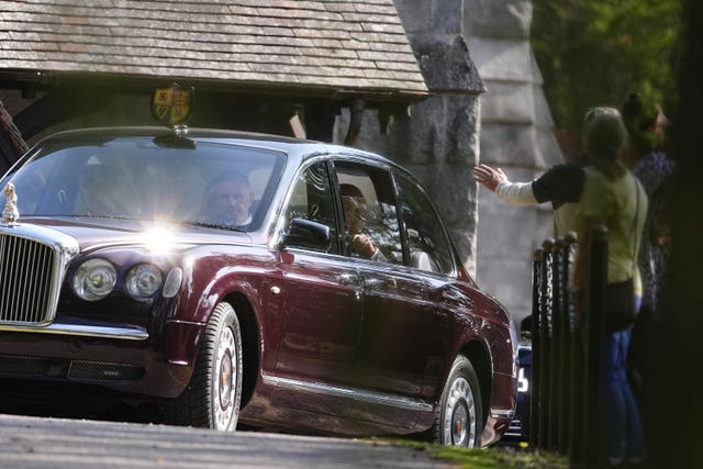 The King and Queen leaving the church in the back of the state Bentleyafter the hour-long service