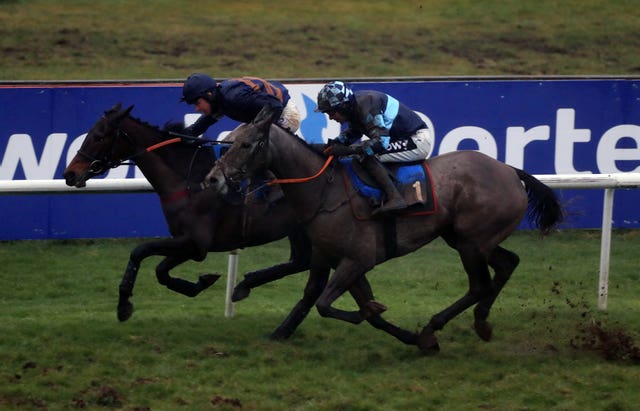 Fontaine Collonges, left, on the way to completing trebles for Venetia Williams and Charlie Deutsch in the Pertemps Network Novices’ Hurdle (Mike Egerton/PA Images)