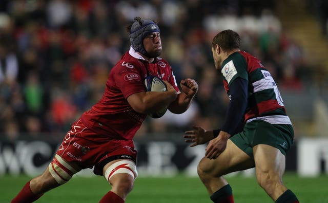 Leicester's Jonah Holmes, right, tackles Scarlets' Will Boyde