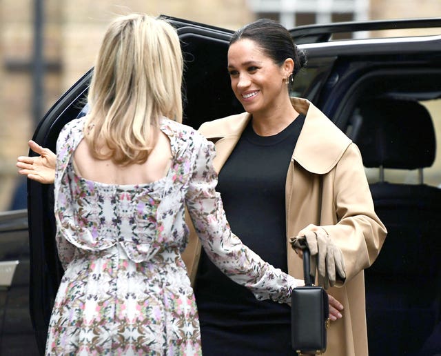 Kate Stephens, CEO of Smart Works, welcomes the Duchess of Sussex (right) as she arrives for her visit (Clodagh Kilcoyne/PA)