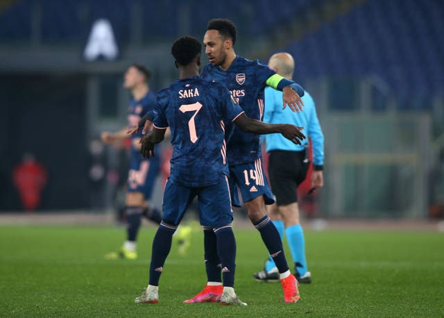 Arsenal's Bukayo Saka (left) celebrates his equaliser against Benfica