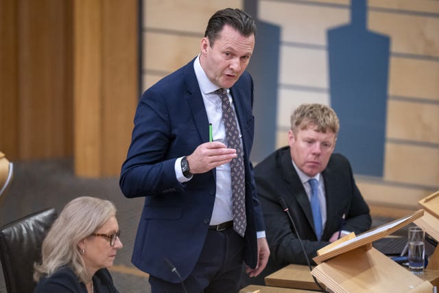 Russell Findlay standing while speaking in Holyrood