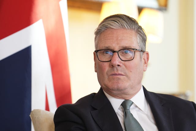 Sir Keir Starmer next to a Union Jack in 10 Downing Street