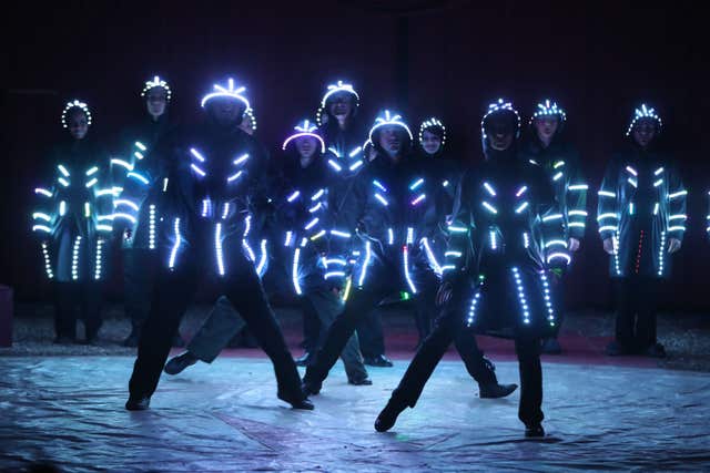 Troupe members wear LED outfits (Niall Carson/PA)