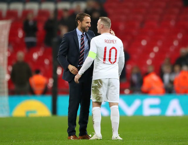 England manager Gareth Southgate shakes hands with Rooney