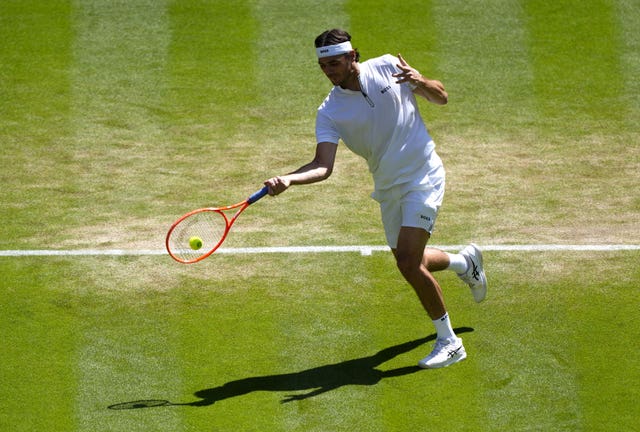 Taylor Fritz hits a forehand