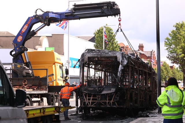 A Glider bus, on the Newtownards Road in east Belfast is removed, after it was set on fire