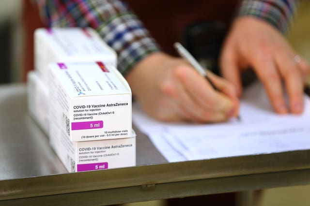 Doses of the Oxford University/AstraZeneca Covid-19 vaccine are logged by a technical officer