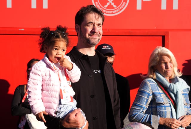 Alexis Ohanian, centre, and daughter Adira, left, watch Serena Williams' comeback