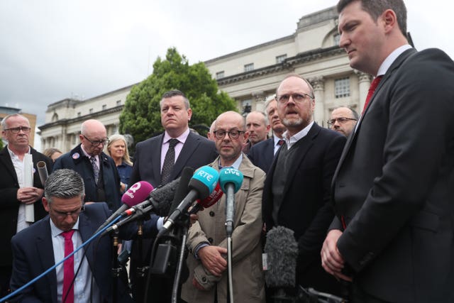 Journalists Trevor Birney and Barry McCaffrey speak to the media as they leave the Royal Courts of Justice in Belfast