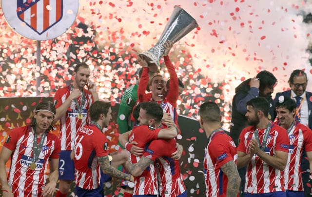 Former Atletico Madrid forward Antoine Griezmann (centre) celebrates