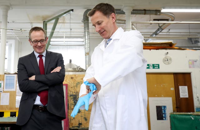 Jeremy Hunt puts on rubber gloves