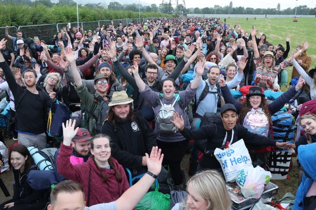 People arrive on the first day of the Glastonbury Festival at Worthy Farm in Somerset