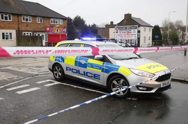 Police at the scene in Collier Row Road (Isabel Infantes/PA)