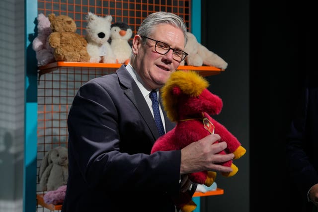 Sir Keir Starmer looking at a doll