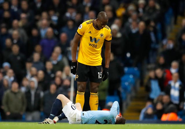 Willy Boly stands over Manchester City’s Bernardo Silva prior to his dismissal