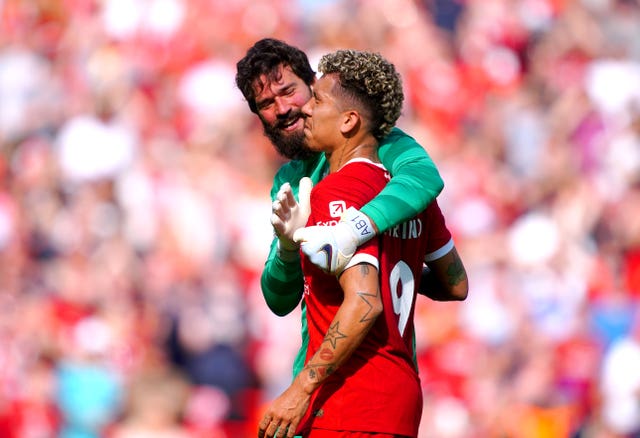 Roberto Firmino is hugged by goalkeeper Alisson