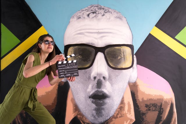 Isobel Salamon poses alongside the Leith Trainspotting murals