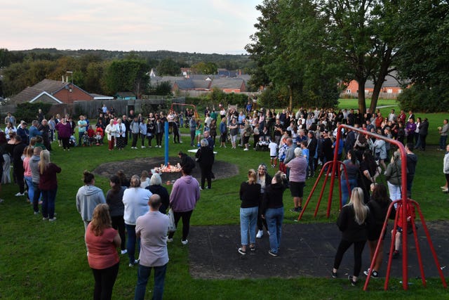 Members of the public attend a vigil near to the scene in Chandos Crescent, Killamarsh