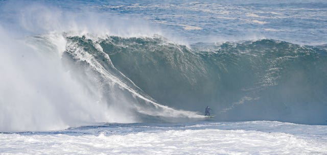 Surfers riding high waves in Mullaghmore, Co Sligo