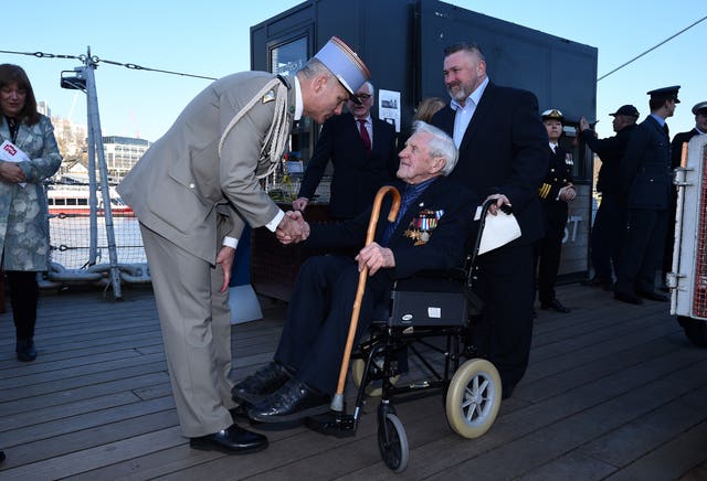 John Nicholls is welcomed onboard HMS Belfast