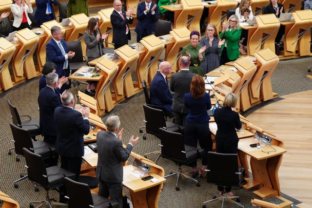 MSPs clap as John Swinney is re-elected as First Minister at the Scottish Parliament in Edinburgh